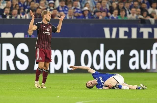 Sport Bilder des Tages 13.04.2024 - Fussball - Saison 2023 2024 - 2. Fussball - Bundesliga - 29. Spieltag: FC Schalke 04 S04 ( Knappen ) - 1. FC Nürnberg FCN ( Club ) - Sportfoto Zink DaMa - xdaxmax - DFL regulations prohibit any use of photographs as image sequences and or quasi-video - only for editorial use - Sebastian Andersson (20, 1. FC Nürnberg FCN ) gestikuliert unschuldig nach Fou an Derry John Murkin (5, FC Schalke 04 S04 )