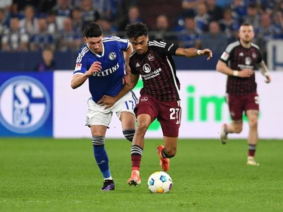 13.04.2024, Gelsenkirchen, Germany, VELTINS-Arena, FC Schalke 04 vs 1. FC Nuernberg - 2. Bundesliga, Yusuf Kabadayi (FC Schalke 04) und Nathaniel Brown (1. FC Nuernberg) im Zweikampf (Foto Ralf Treese) DFB DFL REGULATIONS PROHIBIT ANY USE OF PHOTOGRAPHS AS IMAGE SEQUENCES AND OR QUASI-VIDEO. Gelsenkirchen VELTINS-Arena North Rhine-Westphalia Germany