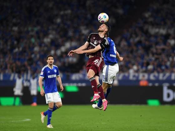 13.04.2024, Gelsenkirchen, Germany, VELTINS-Arena, FC Schalke 04 vs 1. FC Nuernberg - 2. Bundesliga, Lukas Schleimer (1. FC Nuernberg) und Ron Schallenberg (FC Schalke 04) im Zweikampf (Foto Ralf Treese) DFB DFL REGULATIONS PROHIBIT ANY USE OF PHOTOGRAPHS AS IMAGE SEQUENCES AND OR QUASI-VIDEO. Gelsenkirchen VELTINS-Arena North Rhine-Westphalia Germany