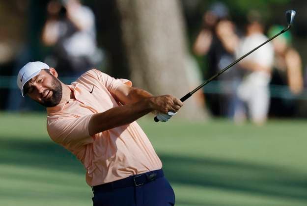 Scottie Scheffler hits an approach shot on the fifteenth hole on the final day of the Masters Tournament at Augusta National Golf Club in Augusta, Georgia on Sunday, April 14, 2024.  AUG20240414138 JOHNxANGELILLO