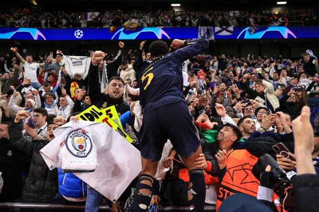 Football - UEFA Champions League - Quarter Final (2nd Leg) - Manchester City v Real Madrid 17th April 2024 - UEFA Champions League - Quarter Final (2nd Leg) - Manchester City v Real Madrid - Jude Bellingham of Real Madrid climbs into the crowd to celebrate their victory on penalties - Photo: Simon Stacpoole Offside. Manchester UK Copyright: xSimonxStacpoolexOffside