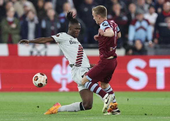 London, England, 18th April 2024. Odilon Kossounou of Bayer Leverkusen tackles James Ward-Prowse of West Ham United and receives a yellow card during the UEFA Europa League match at the London Stadium, London. Picture credit should read: David Klein Sportimage EDITORIAL USE ONLY. No use with unauthorised audio, video, data, fixture lists, club league logos or live services. Online in-match use limited to 120 images, no video emulation. No use in betting, games or single club league player publications. SPI-3091-0019