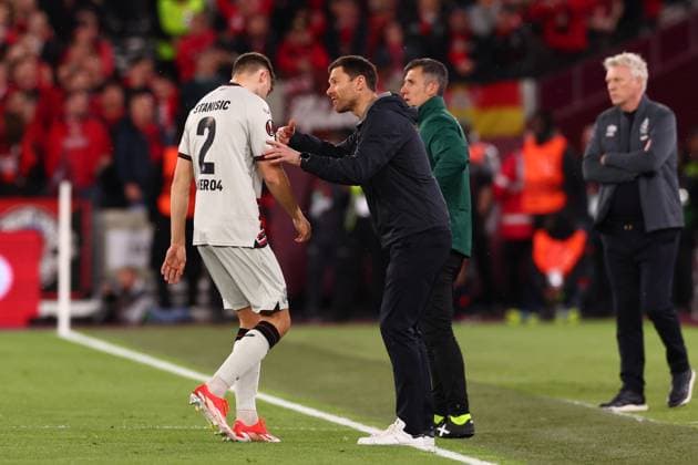 18th April 2024; London Stadium, London, England; Europa League Football, Quarter Final, Second Leg, West Ham United versus Bayer Leverkusen; Bayer Leverkusen Manager Xabi Alonso speaks with Josip Stanisic  ActionPlus12631762 ShaunxBrooks