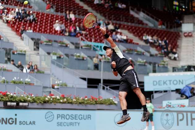 MADRID, SPAIN - APRIL 25: Yoshihito Nishioka returns a shot against Felix Auger during their match on Day 4 of the Mutua Madrid Open at Caja Magica Stadium in Madrid. ONLYxEDITORIALxUSAGE  (251219015)