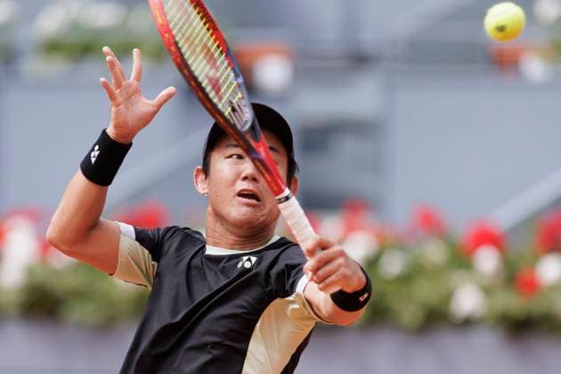 MADRID, SPAIN - APRIL 25: Yoshihito Nishioka returns a shot against Felix Auger during their match on Day 4 of the Mutua Madrid Open at Caja Magica Stadium in Madrid. ONLYxEDITORIALxUSAGE  (251219064)