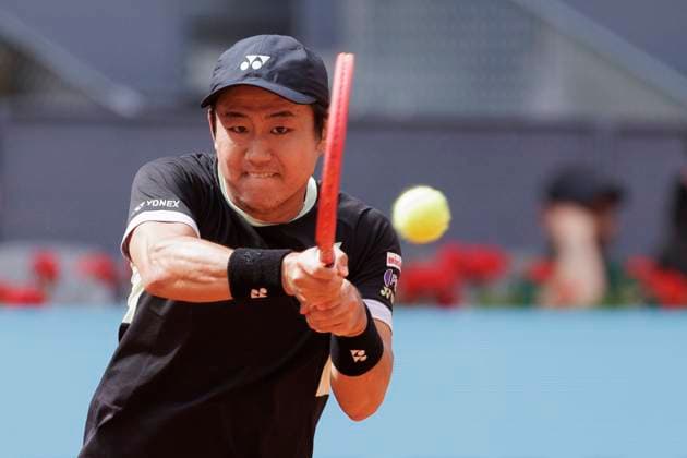 MADRID, SPAIN - APRIL 25: Yoshihito Nishioka returns a shot against Felix Auger during their match on Day 4 of the Mutua Madrid Open at Caja Magica Stadium in Madrid. ONLYxEDITORIALxUSAGE  (251219107)