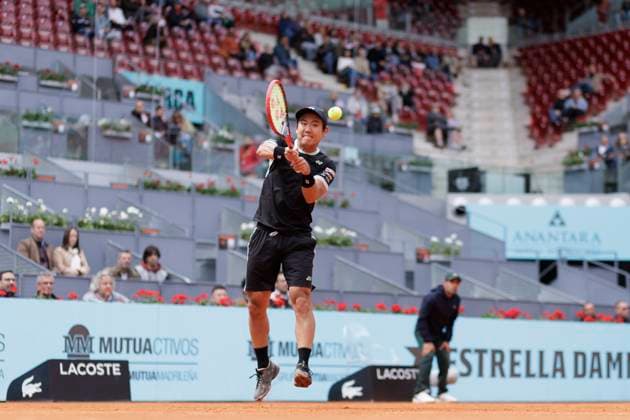 MADRID, SPAIN - APRIL 25: Yoshihito Nishioka returns a shot against Felix Auger during their match on Day 4 of the Mutua Madrid Open at Caja Magica Stadium in Madrid. ONLYxEDITORIALxUSAGE  (251219179)