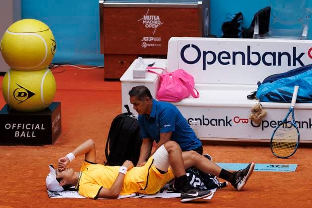 MADRID, SPAIN - APRIL 26: Juncheng Shang needs medical assistance during their match on Day 5 of the Mutua Madrid Open at Caja Magica Stadium in Madrid. ONLYxEDITORIALxUSAGE  (251343628)