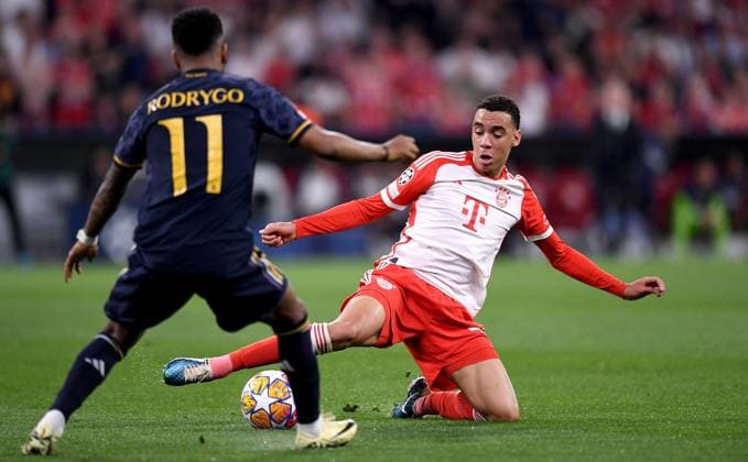 FUSSBALL CHAMPIONS LEAGUE SAISON 2023 2024 Halbfinale, Hinspiel FC Bayern Muenchen - Real Madrid 30.04.2024 Rodrygo (li, Real Madrid) gegen Jamal Musiala (re, FC Bayern Muenchen)