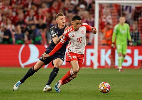 (240501) -- MUNICH, May 1, 2024 -- Jamal Musiala (R) of Bayern Munich vies with Toni Kroos of Real Madrid during the UEFA Champions League semifinal 1st Leg football match between Bayern Munich and Real Madrid in Munich, Germany, April 30, 2024. (Photo by Xinhua) (SP)GERMANY-MUNICH-FOOTBALL-UEFA CHAMPIONS LEAGUE-BAYERN MUNICH VS REAL MADRID PhilippexRuiz 