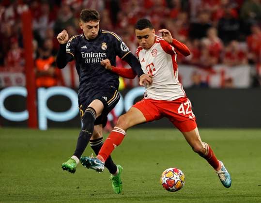 (240501) -- MUNICH, May 1, 2024 -- Jamal Musiala (R) of Bayern Munich vies with Federico Valverde of Real Madrid during the UEFA Champions League semifinal 1st Leg football match between Bayern Munich and Real Madrid in Munich, Germany, April 30, 2024. (Photo by Xinhua) (SP)GERMANY-MUNICH-FOOTBALL-UEFA CHAMPIONS LEAGUE-BAYERN MUNICH VS REAL MADRID PhilippexRuiz 