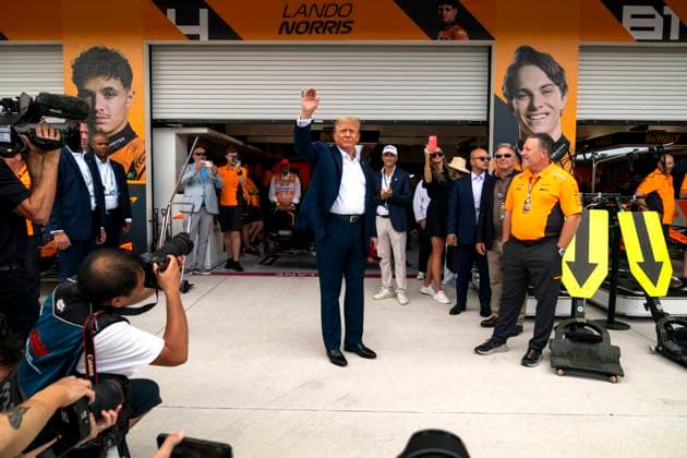 Former U.S. President Donald Trump waves to fans as he visits the garage of McLaren F1 Team with team principal Zak Brown during the Formula One Miami Grand Prix at the Miami International Autodrome in Miami Gardens, Florida on Sunday, May 5, 2024  MIA20240505428 GREGxNASH