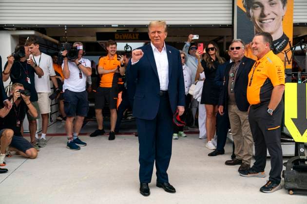 Former U.S. President Donald Trump raises his fist as he visits the garage of McLaren F1 Team with team principal Zak Brown during the Formula One Miami Grand Prix at the Miami International Autodrome in Miami Gardens, Florida on Sunday, May 5, 2024  MIA20240505422 GREGxNASH