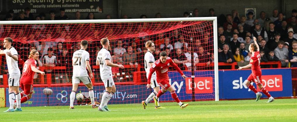Liam Kelly of Crawley (centre) starts to celebrate after scoring early on during the Sky Bet EFL League Two play-offs semi final first leg match between Crawley Town and MK Dons at the Broadfield Stadium , Crawley , UK - 7th May, 2024 Crawley Town v MK Dons League Two play-offs first leg match, Broadfield Stadium, Crawley, United Kingdom - 07 May 2024 Editorial use only. No merchandising. For Football images FA and Premier League restrictions apply inc. no internet mobile usage without FAPL license - for details contact Football Dataco  Copyright: xSimonxDack TPI Shutterstockx 14467269q