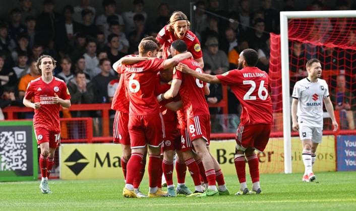 The Crawley players leap on top of Liam Kelly after he had scored an early goal during the Sky Bet EFL League Two play-offs semi final first leg match between Crawley Town and MK Dons at the Broadfield Stadium , Crawley , UK - 7th May, 2024 Crawley Town v MK Dons League Two play-offs first leg match, Broadfield Stadium, Crawley, United Kingdom - 07 May 2024 Editorial use only. No merchandising. For Football images FA and Premier League restrictions apply inc. no internet mobile usage without FAPL license - for details contact Football Dataco  Copyright: xSimonxDack TPI Shutterstockx 14467269t