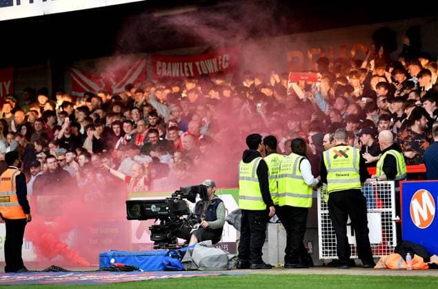Crawley fans let off a flare after taking a first half lead during the Sky Bet EFL League Two play-offs semi final first leg match between Crawley Town and MK Dons at the Broadfield Stadium , Crawley , UK - 7th May, 2024 Crawley Town v MK Dons League Two play-offs first leg match, Broadfield Stadium, Crawley, United Kingdom - 07 May 2024 Editorial use only. No merchandising. For Football images FA and Premier League restrictions apply inc. no internet mobile usage without FAPL license - for details contact Football Dataco  Copyright: xSimonxDack TPI Shutterstockx 14467269w