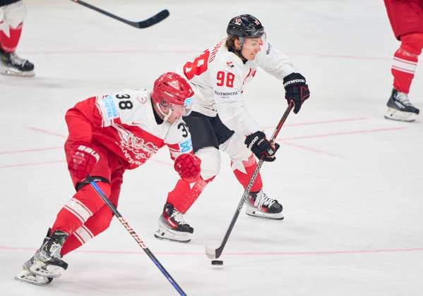 Connor Bedard CAN 98 compete, fight for the puck against, Morten POULSEN, DEN 38 in the preliminary round match DENMARK - CANADA of the IIHF Ice hockey, Eishockey World Championship, WM, Weltmeisterschaft Group A in Prague, Czechia, May 12, 2024, Season 2023 2024