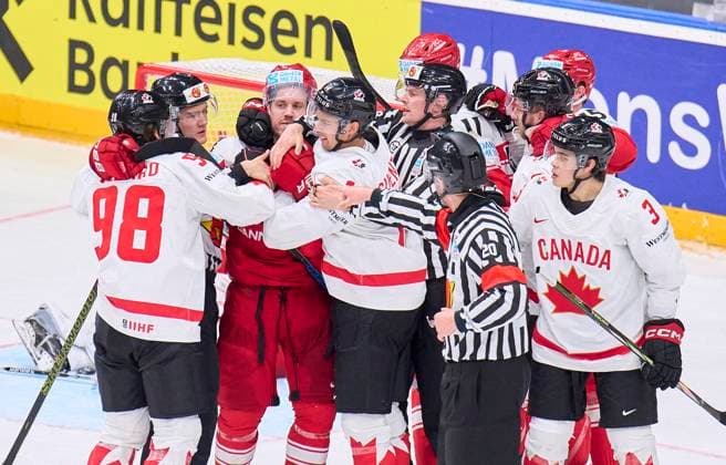 Connor Bedard CAN 98 Dylan Guenther CAN 14 fighting with Jesper JENSEN AABO, DEN 41 Alexander True, DEN 11 in the preliminary round match DENMARK - CANADA 1-5 of the IIHF Ice hockey, Eishockey World Championship, WM, Weltmeisterschaft Group A in Prague, Czechia, May 12, 2024, Season 2023 2024