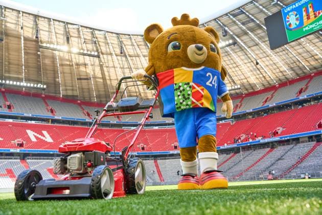 Munich, Bavaria, Germany - May 13, 2024: The mascot of UEFA EURO, EM, Europameisterschaft,Fussball 2024, a teddy bear called Albärt. Mascot of the European Championship, EM, Europameisterschaft symbolically mows the lawn of the Allianzarena pitch in Munich