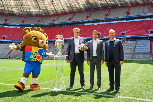 Munich, Bavaria, Germany - 13 May 2024: Prime Minister Dr. Markus Söder (CSU) together with FIFA referee Felix Brych on the soccer pitch of the Allianz Arena in Munich, next to the Henri Delaunay Cup of UEFA EURO, EM, Europameisterschaft,Fussball 2024