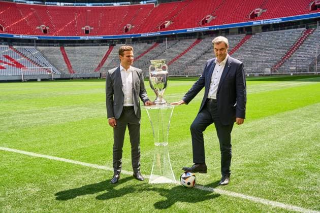 Munich, Bavaria, Germany - 13 May 2024: Prime Minister Dr. Markus Söder (CSU) together with FIFA referee Felix Brych on the soccer pitch of the Allianz Arena in Munich, next to the Henri Delaunay Cup of UEFA EURO, EM, Europameisterschaft,Fussball 2024
