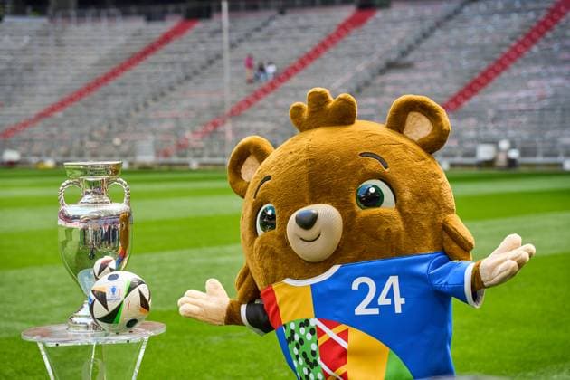 Munich, Bavaria, Germany - 13 May 2024: EURO 2024 soccer theme picture: European Championship, EM, Europameisterschaft Albärt mascot stands on the Allianz Arena pitch together with the official Adidas match ball and the UEFA EURO, EM, Europameisterschaft,Fussball 2024 Henri Delaunay Cup