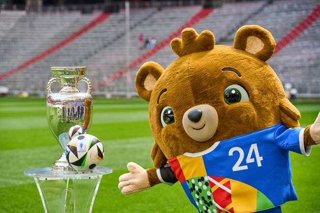 Munich, Bavaria, Germany - 13 May 2024: EURO 2024 soccer theme picture: European Championship, EM, Europameisterschaft Albärt mascot stands on the Allianz Arena pitch together with the official Adidas match ball and the UEFA EURO, EM, Europameisterschaft,Fussball 2024 Henri Delaunay Cup