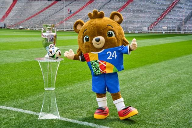 Munich, Bavaria, Germany - 13 May 2024: EURO 2024 soccer theme picture: European Championship, EM, Europameisterschaft Albärt mascot stands on the Allianz Arena pitch together with the official Adidas match ball and the UEFA EURO, EM, Europameisterschaft,Fussball 2024 Henri Delaunay Cup