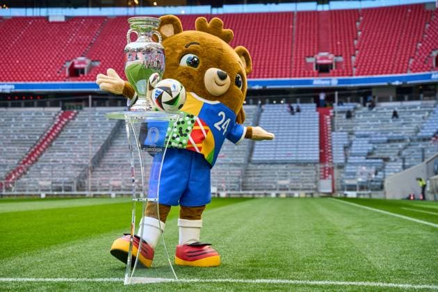 Munich, Bavaria, Germany - 13 May 2024: EURO 2024 soccer theme picture: European Championship, EM, Europameisterschaft Albärt mascot stands on the Allianz Arena pitch together with the official Adidas match ball and the UEFA EURO, EM, Europameisterschaft,Fussball 2024 Henri Delaunay Cup