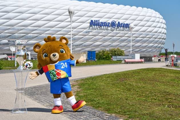 Munich, Bavaria, Germany - May 13, 2024: UEFA EURO, EM, Europameisterschaft,Fussball 2024 mascot Albärt with the Adidas match ball and the Henri Delaunay Cup in front of the Allianz Arena in Munich