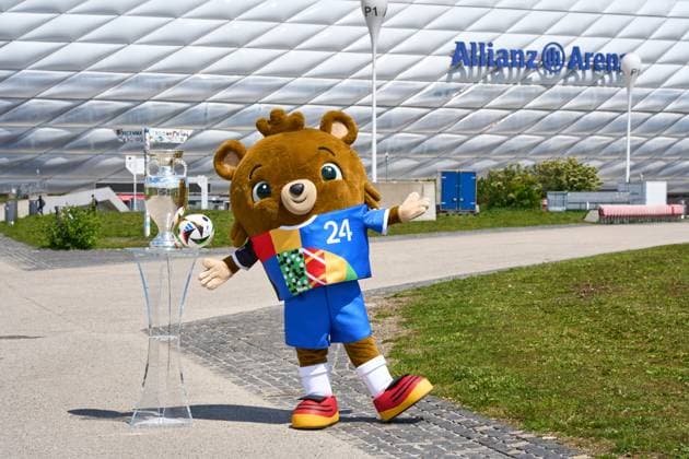 Munich, Bavaria, Germany - May 13, 2024: UEFA EURO, EM, Europameisterschaft,Fussball 2024 mascot Albärt with the Adidas match ball and the Henri Delaunay Cup in front of the Allianz Arena in Munich