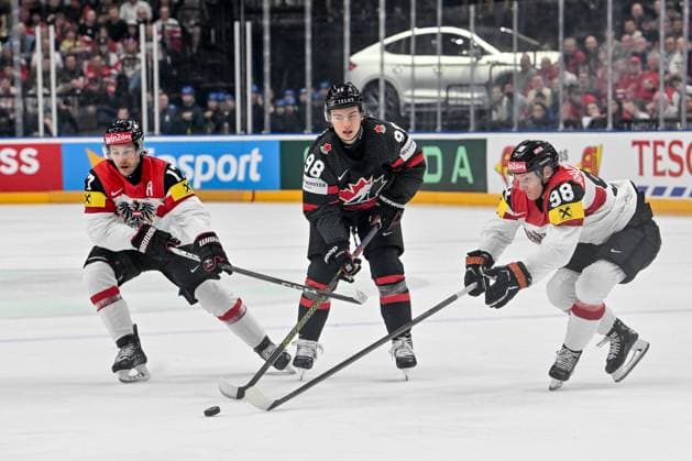 PRAGUE, CZECH REPUBLIC - MAY 14: Connor Bedard of Canada chases the puck with Manuel Ganahl of Austria (L) and Benjamin Baumgartner of Austria (R) during the preliminary round match between Canada and Austria at Prague Arena on May 14, 2024 in Prague, Czech Republic. Prague Czech Republic Copyright: xJustPictures.ch AndreaxBrancax jp-en-EuSpIm-AB_14052024_AAB_8509