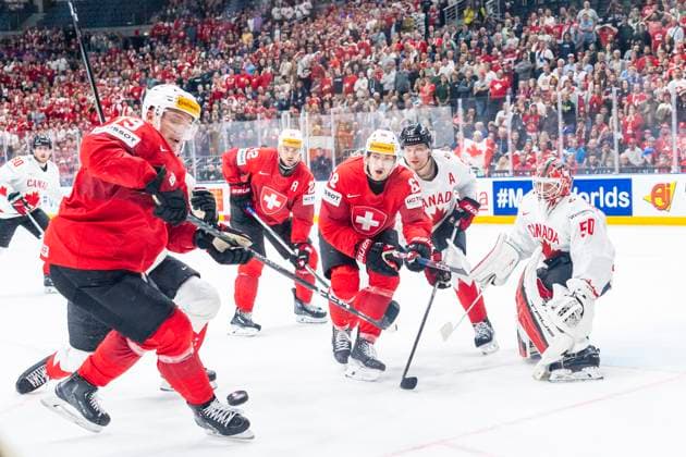 PRAGUE, CZECH REPUBLIC - MAY 19: Calvin Thurkauf of Switzerland (L) and Fabrice Herzog of Switzerland (C) in action against goalkeeper Jordan Binnington of Canada (R) during the preliminary round match between Switzerland and Canada at Prague Arena on May 19, 2024 in Prague, Czech Republic. Prague Prague Arena Czech Republic Copyright: xJustPictures.ch JarixPestelaccix jp-en-EuSpIm-JP4_JAR_Switzerland_Canada_19May2024_288