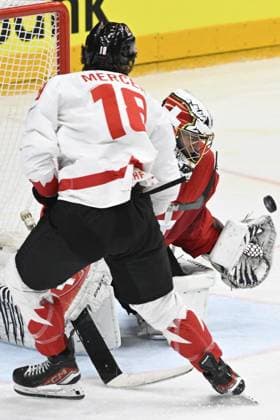 L-R Dawson Mercer (CAN) and goalkeeper Leonardo Genoni (SUI) in action during the 2024 IIHF World Championship, WM, Weltmeisterschaft semi-final match Canada vs Switzerland, in Prague, Czech Republic, on May 25, 2024. (CTKxPhoto MichalxKamaryt) CTKPhotoP2024052506015  CTKPhotoP2024052506015