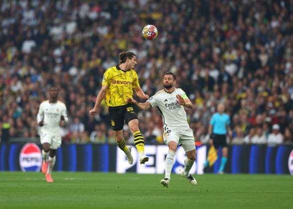 1st June 2024; Wembley Stadium, London, England; UEFA Champions League Football Final, Borussia Dortmund versus Real Madrid; Marcel Sabitzer of Borussia Dortmund heads the ball above Nacho Fernandez of Real Madrid  ActionPlus12649821 JohnxPatrickxFletcher