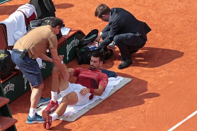 3rd June 2024; Roland Garros, Paris, France; 2024 French Open Tennis tournament, Day 9; Novak Djokovic receives treatment for his knee during his match versus Francisco Cerundolo (arg)  ActionPlus12650693 JonxBromley