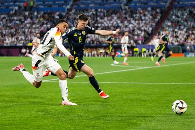 240614 Jamal Musiala of Germany and Kieran Tierney of Scotland during the UEFA EURO, EM, Europameisterschaft,Fussball 2024 Football Championship match between Germany and Scotland on June 14, 2024 in Munich. Photo: Mathias Bergeld BILDBYRAN kod MB MB0933 fotboll football soccer fotball fotbolls-em europamästerskap em uefa euro uefa european football championship euro 2024 tyskland germany scotland bbeng skottland Copyright: MATHIASxBERGELD BB240614MB057