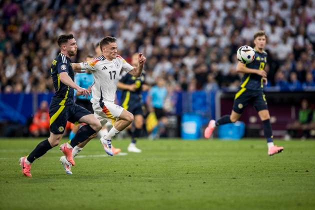 UEFA EURO 2024: Eröffnungsspiel Deutschland - Schottland; 14.06.2024 Florian Wirtz (Deutschland, 17), Andrew Robertson (Schottland, 3). UEFA EURO 2024: Eröffnungsspiel Deutschland - Schottland; Munich Football Arena, München am 14.06.2024 Copyright: xBEAUTIFULxSPORTS Wunderlx
