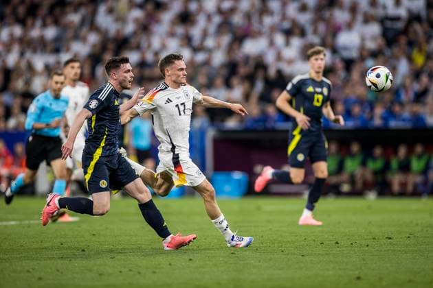 UEFA EURO 2024: Eröffnungsspiel Deutschland - Schottland; 14.06.2024 Florian Wirtz (Deutschland, 17), Andrew Robertson (Schottland, 3). UEFA EURO 2024: Eröffnungsspiel Deutschland - Schottland; Munich Football Arena, München am 14.06.2024 Copyright: xBEAUTIFULxSPORTS Wunderlx