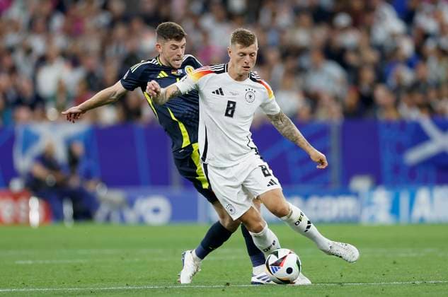 14.06.2024, Fussball, Europameisterschaft, Germany - Scotland, GER, Munich, Munich Football Arena, Bild: v. li. Ryan Christie (Scotland, 11) und Toni Kroos (Germany, 8) Copyright: HMBxMedia xHeikoxBecker