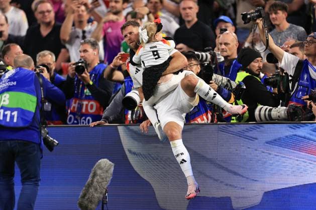 Football - UEFA EURO, EM, Europameisterschaft,Fussball 2024 - Group A - Germany v Scotland 14th June 2024 - UEFA EURO 2024 - Group A - Germany v Scotland - Niclas Fullkrug of Germany goes to the stands to pick up his daughter - Photo: Simon Stacpoole Offside. Munich Germany Copyright: xSimonxStacpoolexOffside