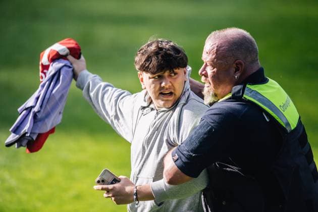 Portugal Public Training Session And press conference, PK, Pressekonferenz - UEFA EURO, EM, Europameisterschaft,Fussball 2024 A security man is holding a fan after storming the pitch during the public training session of Portugal ahead of the UEFA EURO 2024 in Gutersloh, Germany, on June 14, 2024. Gutersloh Germany  Copyright: xHeshamxElsherifx originalFilename:elsherif-notitle240614_np3aX.jpg