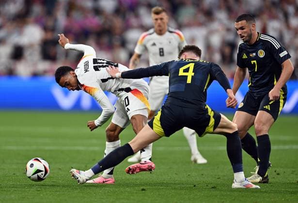 14.06.2024, xscotx, Fussball EM 2024, Deutschland - Schottland, emspor, v.l. Jamal Musiala (Deutsche Fussball Nationalmannschaft DFB), Scott Mctominay (Team Schottland), John Mcginn (Team Schottland) München