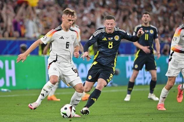 Bild zeigt: v.l.n.r. Joshua Kimmich (6, Deutschland), Callum McGregor (8, Schottland), 14.06.2024, München, Fussball, Europameisterschaft, Deutschland - Schottland, EVENT REGULATIONS PROHIBIT ANY USE OF PHOTOGRAPHS AS IMAGE SEQUENCES AND OR QUASI-VIDEO.