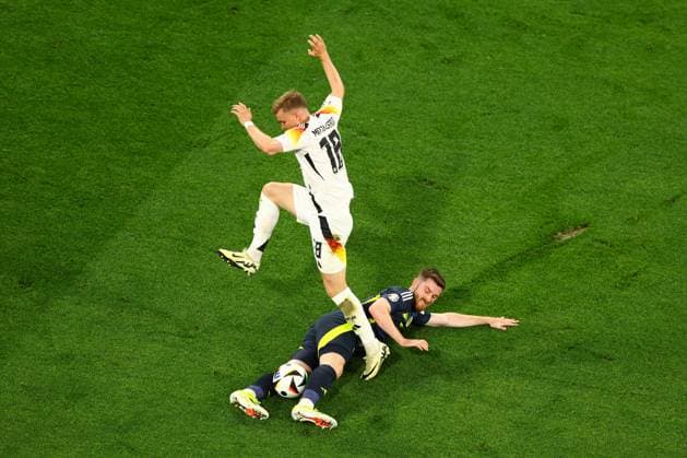 Maximilian Mittelstädt of Germany is challenged by Anthony Ralston of Scotland Germany v Scotland, UEFA European Championship, EM, Europameisterschaft 2024, Group A, Football, Munich Football Arena, Munich, Germany, 14 Jun 2024 EDITORIAL USE ONLY No use with unauthorised audio, video, data, fixture lists, club league logos or live services. Online in-match use limited to 120 images, no video emulation. No use in betting, games or single club league player publications.  Copyright: xKieranxMcManus Shutterstockx 14523770dv