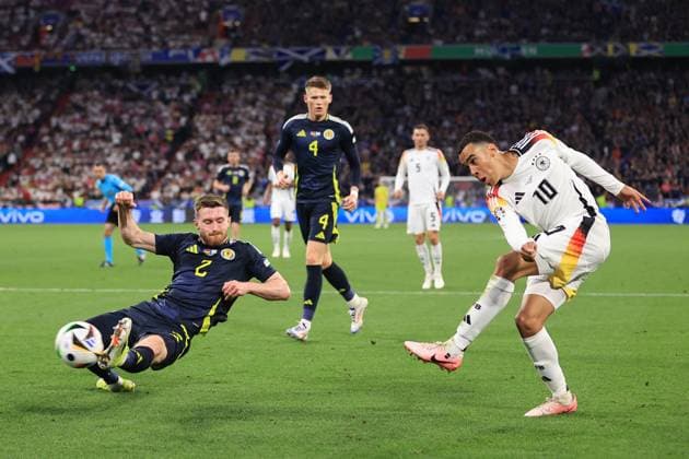 Football - UEFA EURO, EM, Europameisterschaft,Fussball 2024 - Group A - Germany v Scotland 14th June 2024 - UEFA EURO 2024 - Group A - Germany v Scotland - Jamal Musiala of Germany crosses the ball past Anthony Ralston of Scotland - Photo: Simon Stacpoole Offside. Munich Germany Copyright: xSimonxStacpoolexOffside
