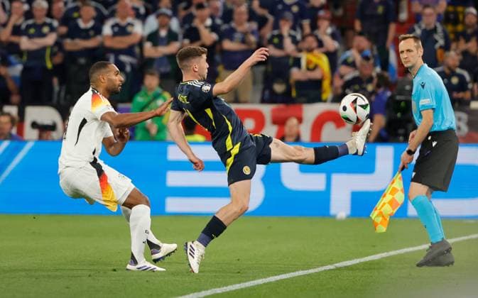 14.06.2024, Fussball Europameisterschaft, Deutschland vs Schottland, Allianz Arena Muenchen, im Bild: Jonathan Tah (Deutschland) vs Ryan Christie (Schottland)