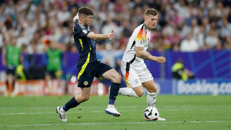 14.06.2024, Fussball, Europameisterschaft, Germany - Scotland, GER, Munich, Munich Football Arena, Bild: v. li. Ryan Christie (Scotland, 11) und Toni Kroos (Germany, 8) Copyright: HMBxMedia xHeikoxBecker