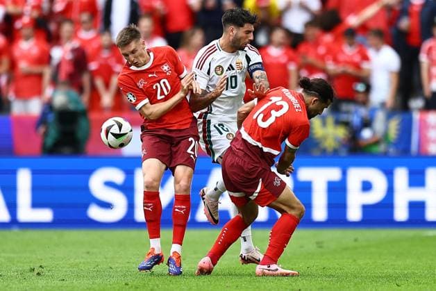 Dominik Szoboszlai of Hungary is challenged by Michel Aebischer of Switzerland and Ricardo Rodriguez of Switzerland Hungary v Switzerland, UEFA European Championship, EM, Europameisterschaft 2024, Group A, Football, Cologne Stadium, Cologne, Germany, 15 Jun 2024 EDITORIAL USE ONLY No use with unauthorised audio, video, data, fixture lists, club league logos or live services. Online in-match use limited to 120 images, no video emulation. No use in betting, games or single club league player publications. Copyright: xMichaelxZemanek Shutterstockx 14539265bk