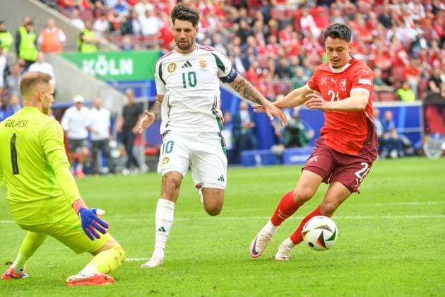 COLOGNE, GERMANY - JUNE 15: Fabian Rieder of Switzerland (R) against Dominik Szoboszlai of Hungary (C) and goalkeeper Peter Gulacsi of Hungary (L) during the UEFA EURO, EM, Europameisterschaft,Fussball 2024 group stage match between Hungary and Switzerland at Cologne Stadium on June 15, 2024 in Cologne, Germany. Cologne Cologne Stadium North Rhine-Westphalia Germany Copyright: xJustPictures.ch ManuelxWinterbergerx jp-en-EuSpIm-MWI_7898